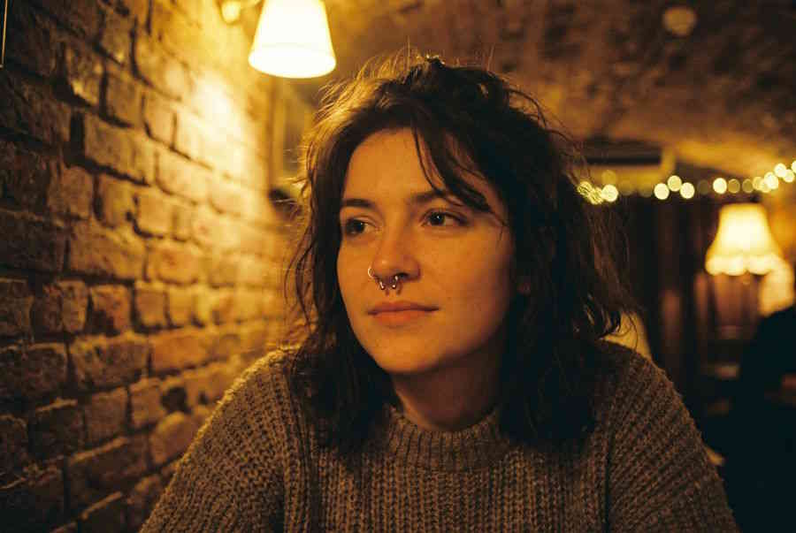 Fake Septum Piercing – Frau mit silbernem Fake Septum Ring in Bar-Atmosphäre